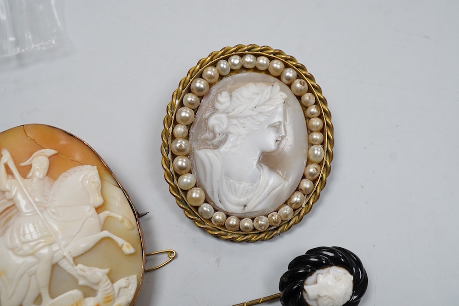 A collection of shell cameo brooches, comprising: a cameo depicting Bacchus, in a gold mount in the Archaeological Revival style, decorated with rope twist and a twisted knife wire border, length 4.4cm; together with sev